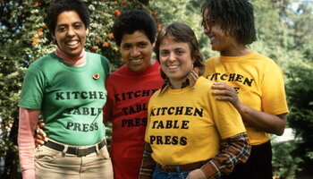 four women of color wearing shirts saying Kitchen Table Press