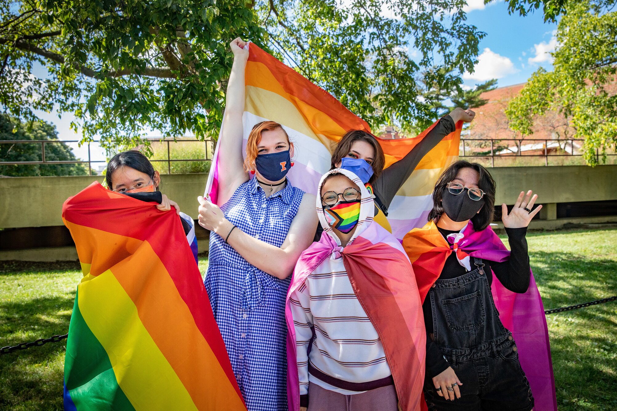 group of students waving pride flags